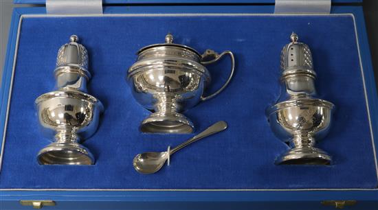 A cased modern silver three piece condiment set by Garrard & Co, London, 1993.